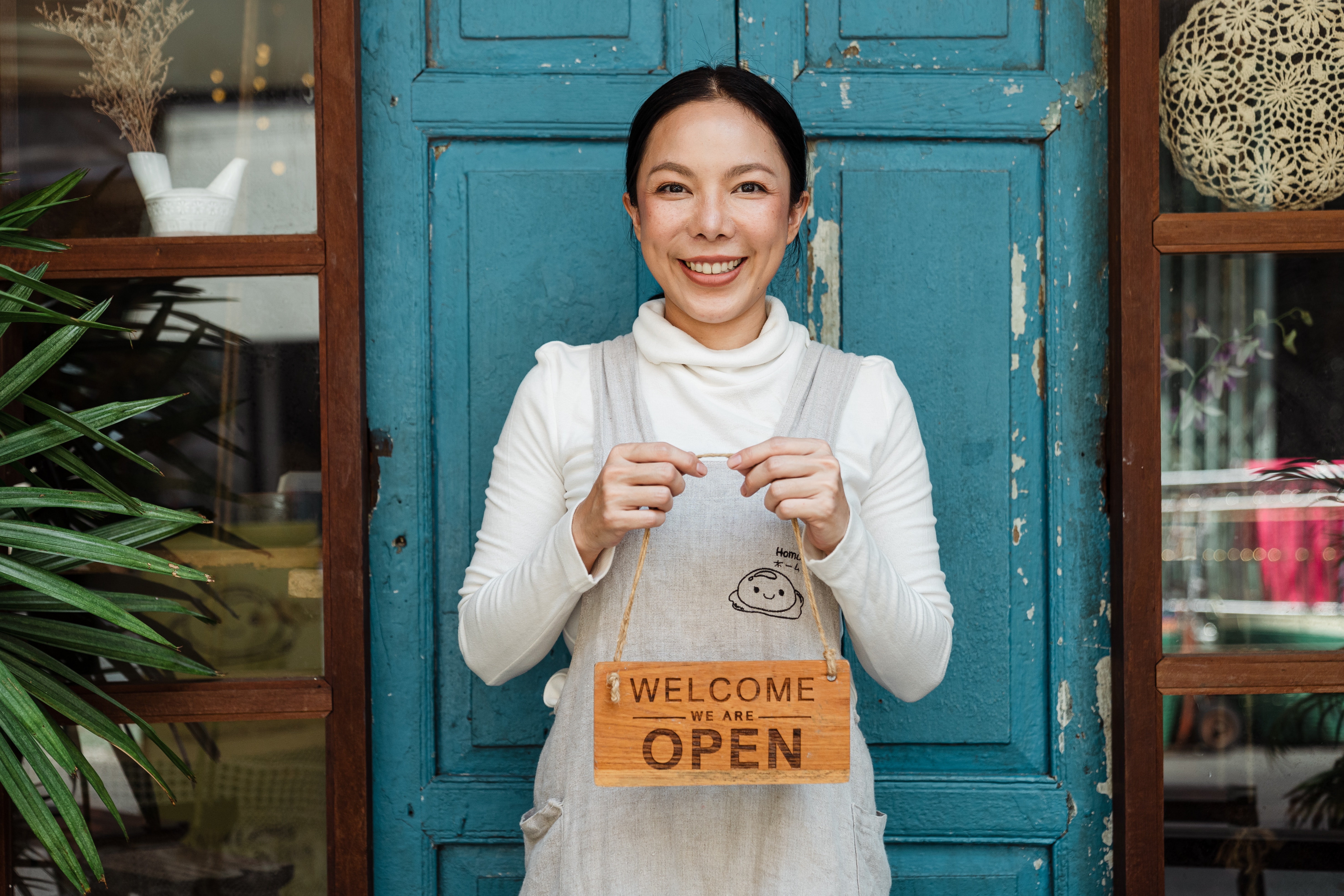 Women with sign open for business