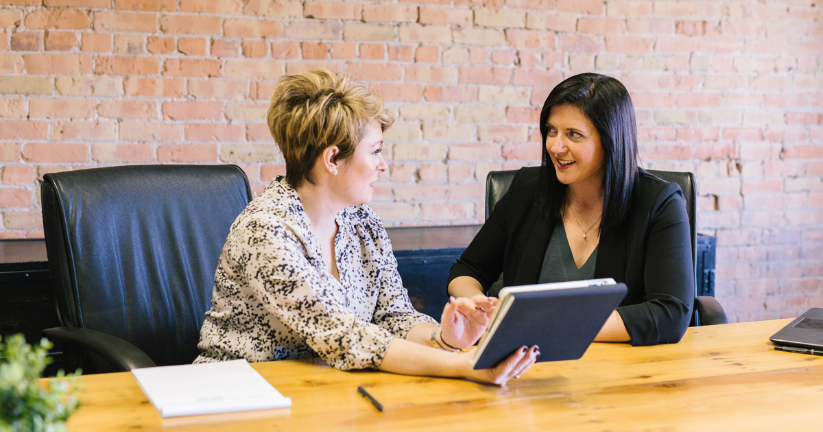 Two women having a discussion during a business meeting