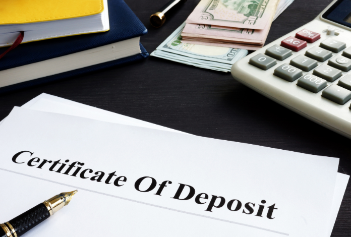 Paper that says Certificate of Deposit with money and a calculator