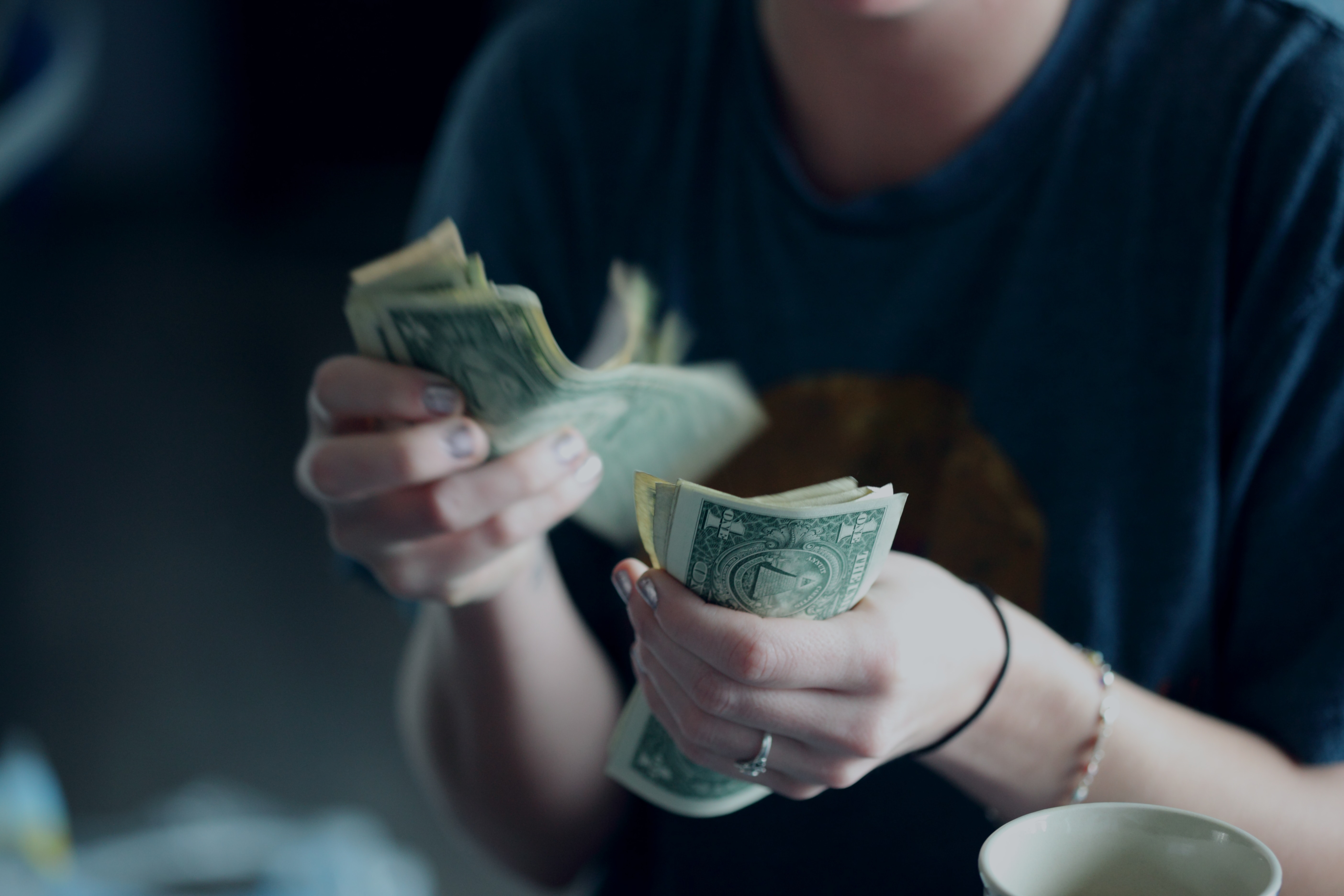 student counting out money to save