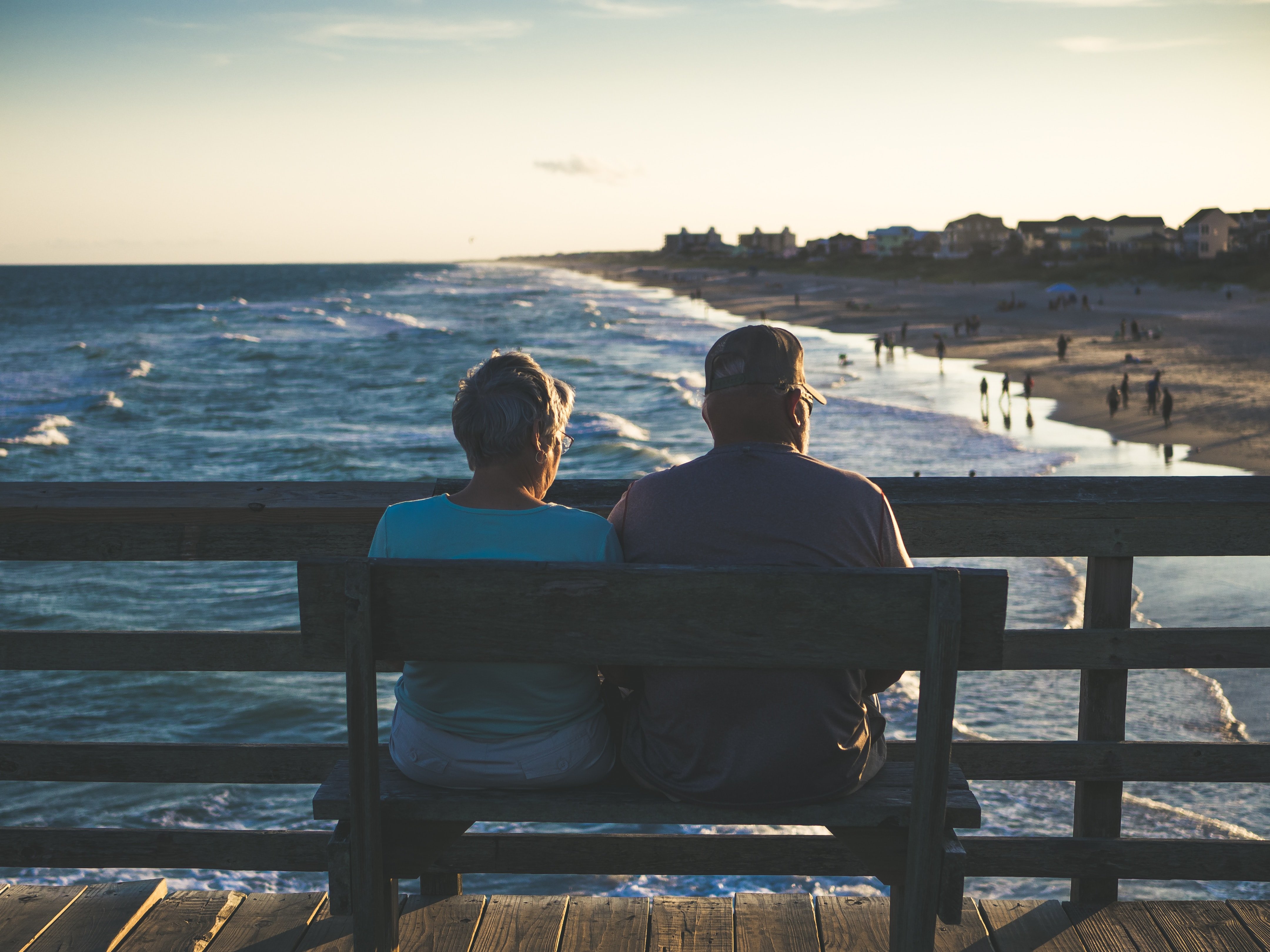 Retired couple beach bench