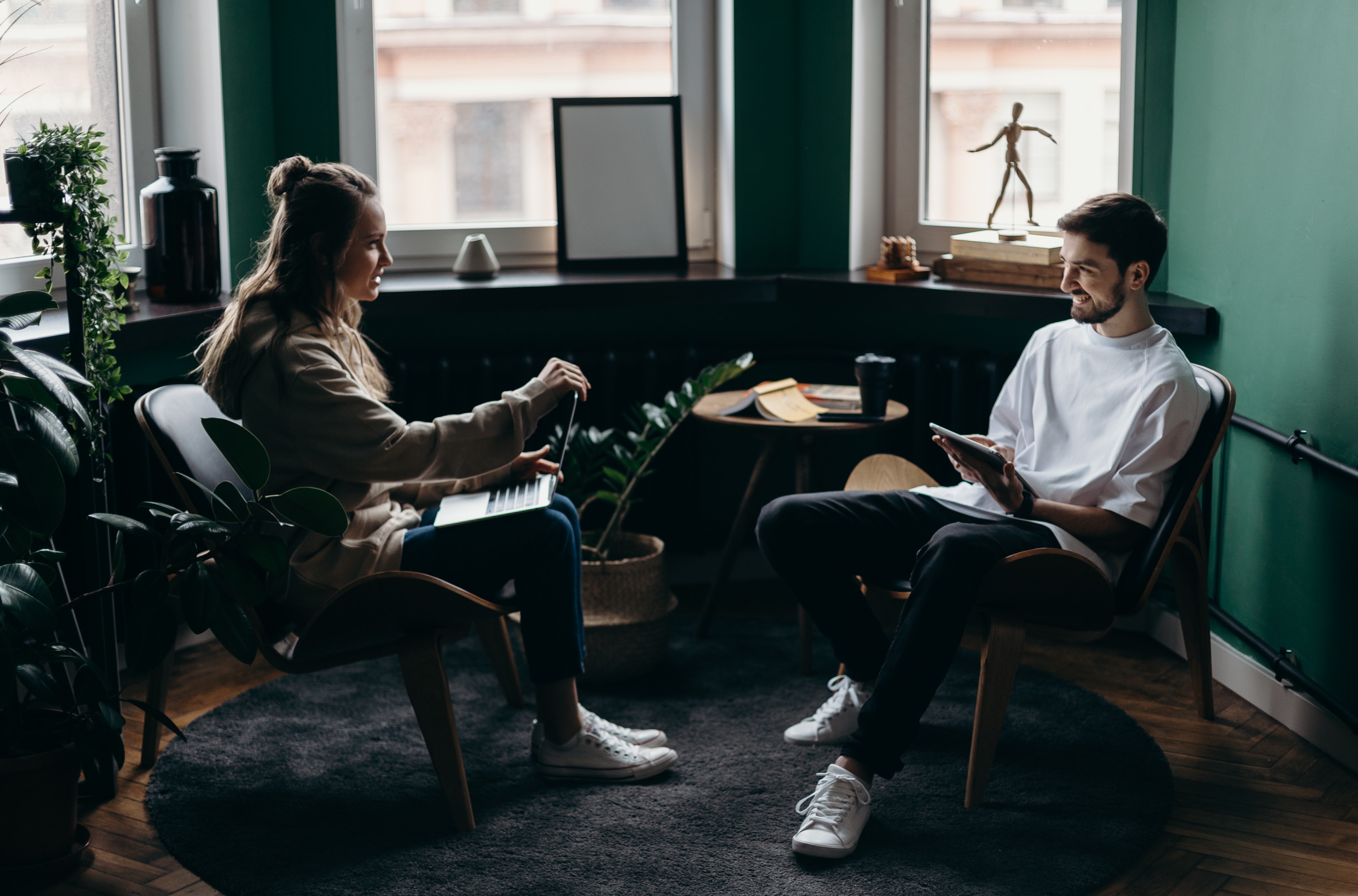 man and woman sitting discussing business ideas