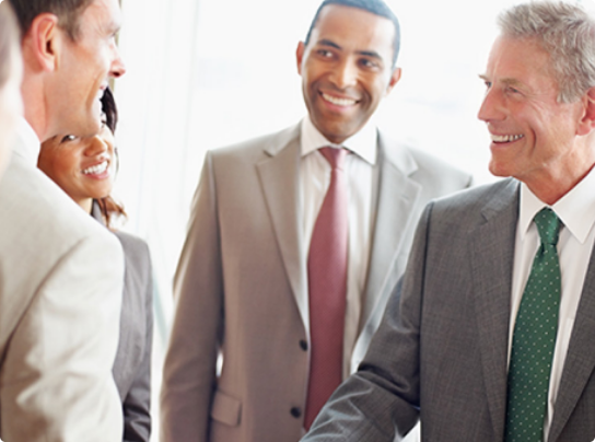 businessmen shaking hands and smiling