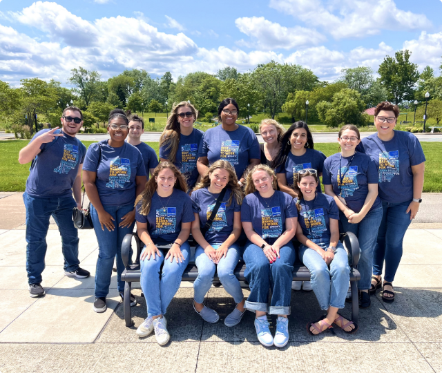 Interns taking a group photo in the park