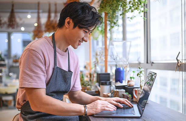 Man on computer in shop